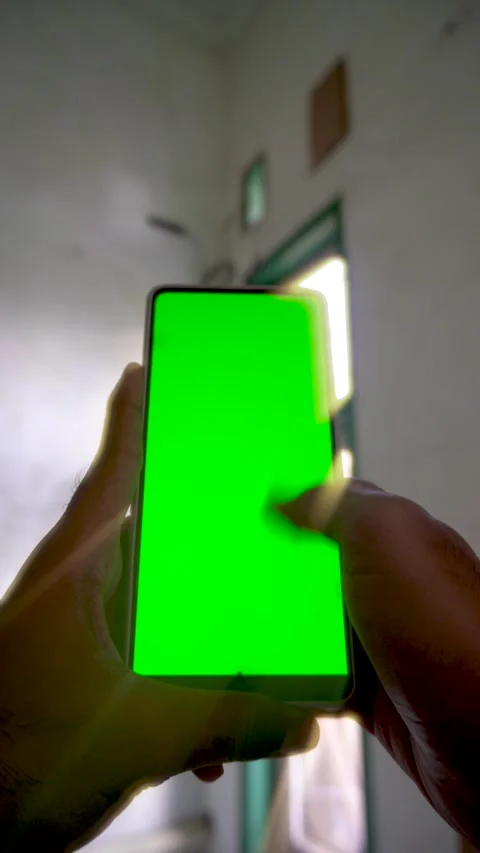 Static vertical smartphone display with a green screen held by a person scr.. Stock Footage 340490905
