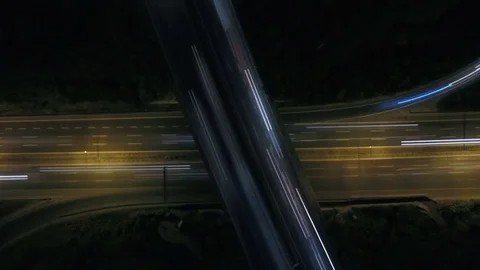 Static vertical top down aerial view of traffic on freeway interchange at night. Stock-Footage 77203446