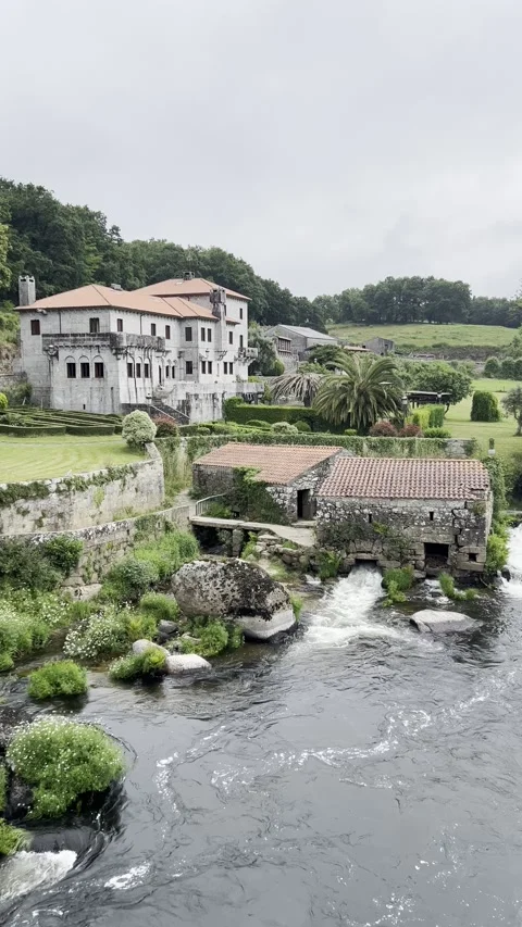 Static Vertical Video of Small Waterfalls, River, and Houses in Negreira, Spain Video stock 310596524