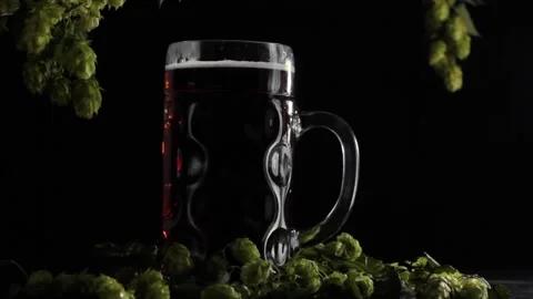 Static video frame with a full beer glass on a wooden background with hops Stock Footage 221547093