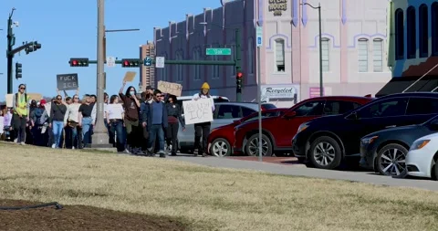 Static video of people protesting the ICE killing of Renee Good in Denton, Texas Stock Footage 327430717