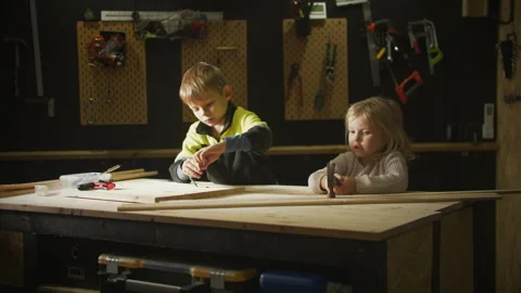 Static view of blonde kids learning practical skills in garage. 스톡 동영상 306576845