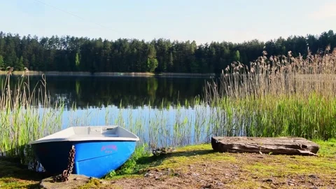 Static view blue boat on shore standing with lake in background.Holiday in Li Stock Footage 157106474