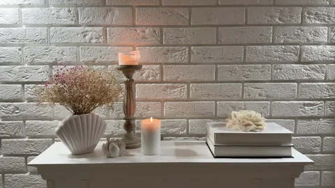 Static view of candles and dried flowers on spruce wooden fireplace mantel Video stock 346084675