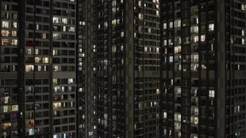 Static view of dense high rise apartment towers with illuminated windows at Video stock 332597270