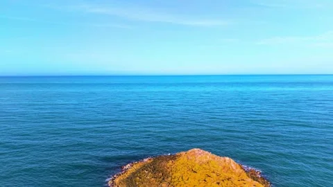 Static View of Golden Coastal Rocks and Deep Blue Sea Under Clear Sky Video stock 341863289