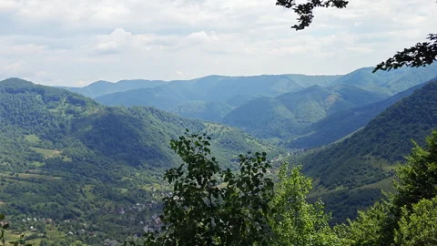Static view of green mountain valley with forested rolling hills 스톡 동영상 337551537