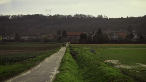 Static view group of people in distance walk in countryside nature in wet wea Video stock 157007525