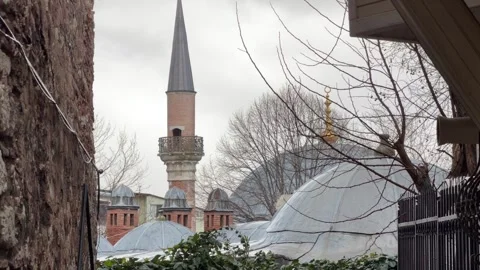 Static view of an minaret and lead-covered domes of a mosque framed by Stock Footage 340155113