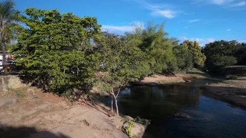 Static view of Rio das Almas rocky banks and green vegetation in Brazil Stock Footage 339298193