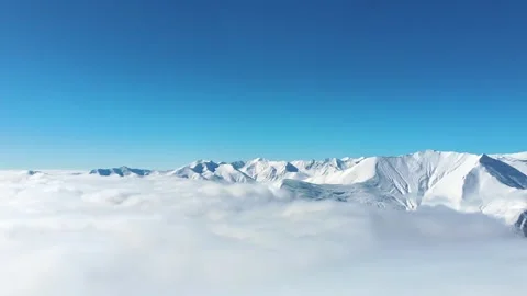 Static view snowy mountains with mist and clouds form layers below snowy pe.. Stock Footage 285245410