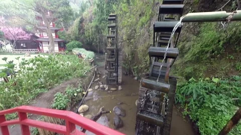 Static view of traditional water wheel in river stream and nature landscape Video stock 345649761