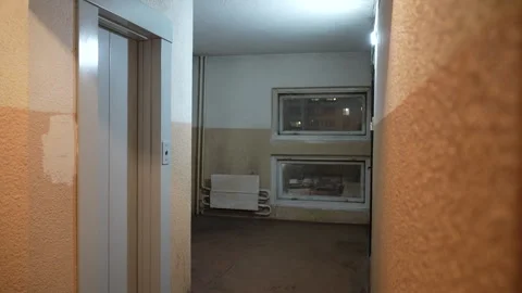 Static view of a vintage apartment corridor with textured walls, elevator door 스톡 동영상 325802130