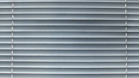 Static view of white closed blinds. light seeps through the blinds Stock Footage 86065233