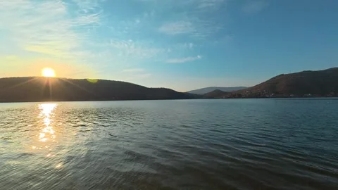 Static Wide-Angle Lake Shot with Gentle Pan – Sunset Behind Hills, Autumn Video stock 330989321