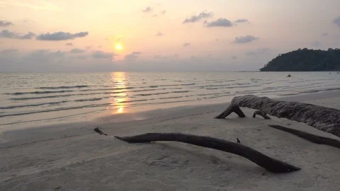 Static wide angle shot of a beautiful empty beach at sunset with large Stock Footage 105765189