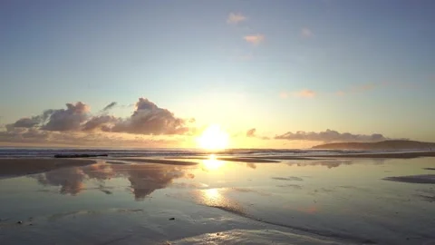 Static Wide Beach Sunrise with Surf and reflections Stock Footage 131129450