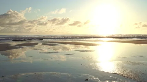Static Wide shot of Beach Sunrise with reflections Stock Footage 131129332