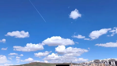 Static wide shot of a bright blue sky over Erzurum with fluffy white clouds and Video stock 334309394