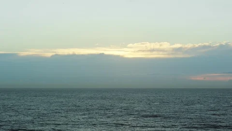 Static wide shot of calm ocean at sunrise/sunset Stock Footage 99324904