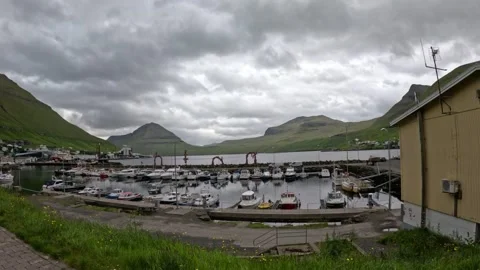 Static wide shot of Klaksvik boat harbor and scenic mountains, Faroe Islands Stock Footage 340067665