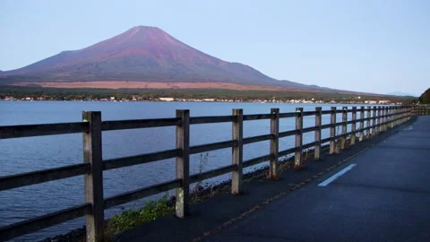 Static wide shot of Mount Fuji above Lake Yamanaka at dawn with walkway Stock Footage 321116006