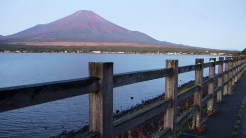 Static wide shot of Mount Fuji above Lake Yamanaka with wooden fence Stock Footage 321116448