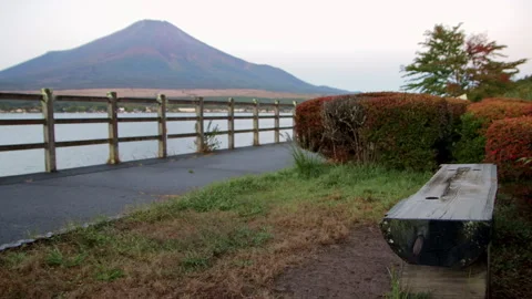 Static wide shot of Mount Fuji and Lake Yamanaka with wooden bench Stock Footage 321117256