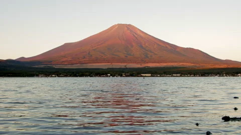 Static wide shot of Mount Fuji above Lake Yamanaka with warm dawn reflections Stock Footage 321118061