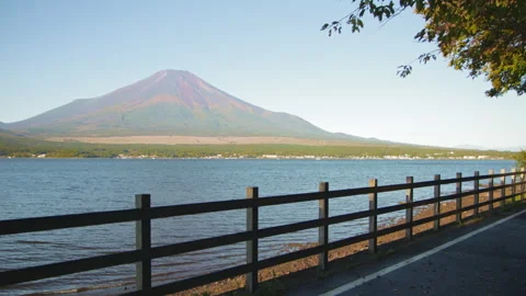Static wide shot of Mount Fuji above Lake Yamanaka with lakeside railing Stock Footage 321122189
