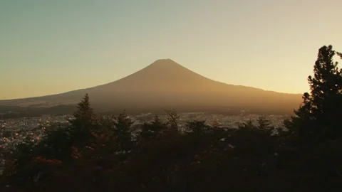 Static wide shot of Mount Fuji at sunset above Fujiyoshida city in Japan Stock Footage 321122967