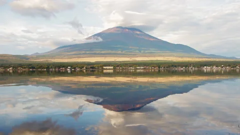 Static wide shot of Mount Fuji with lenticular cloud reflected in Lake Yamanaka Stock Footage 321126434