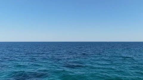 A static wide shot of the open Mediterranean Sea under a clear blue sky, filmed Stock Footage 346712723