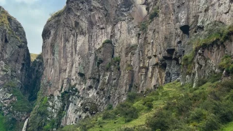 Static Wide Shot of Tiny Rock Climber Scaling Massive Andean Cliff Video stock 327368151