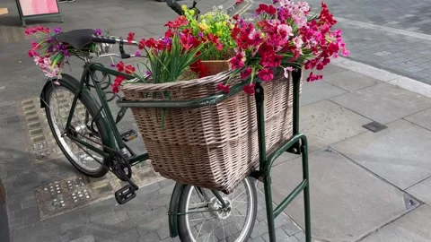 Static wide shot of a vintage bicycle with a flower basket in belgravia london Stock Footage 337366186