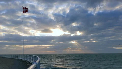 Static - Windy seaside with clouds and Norwegian Flag, sunset Stock Footage 200195858