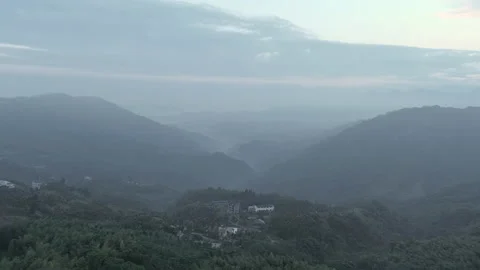 Static, zoom in and out move. Aerial drone shot of twilight at misty tea plan Video stock 172186130