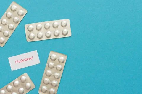 Statin tablets on a blue background Stock Photos