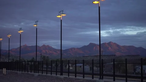 Station platform at nightfall, a disturbing sky, mountains in the background Stock-Footage 131736306