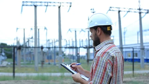 Station technical director with working drawings at nuclear power station. Worke Stock Footage 99645598