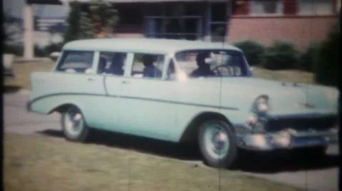 Station wagon, SUV, soccer mom drops off kids 1950s vintage film home movie 2707 Stock Footage
