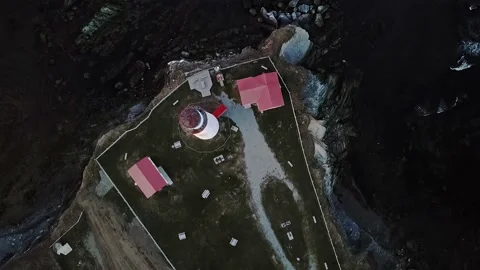 Stationary look down of Cap-des-Rosiers lighthouse with breaking waves on Stock Footage 135843504