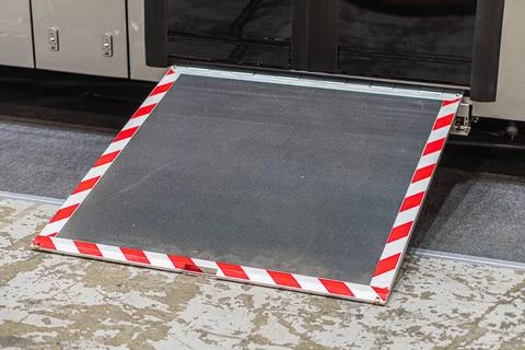 Stationary wheeled accessibility platform with red and white stripes in an in Stock Photos