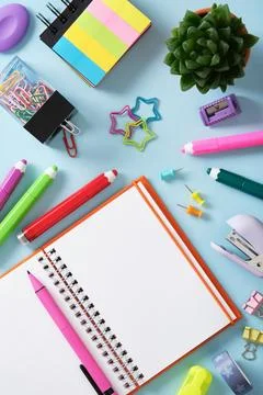 Stationery background with open notepad, felt-tip pens, paper clips, clipbo.. Stock Photos
