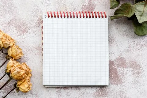 Stationery delicate background-a clean notebook and yellow roses. Top view, c Foto stock