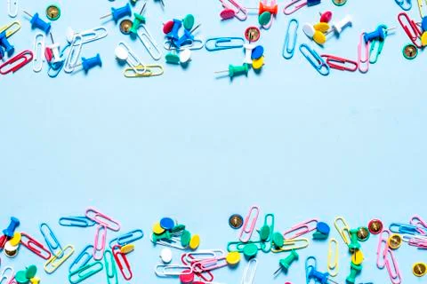Stationery in the form of multi-colored buttons and paper clips on the upper  Stock Photos