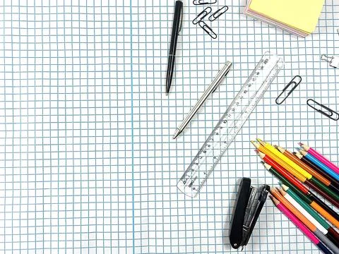 Stationery items on a checkered background. Stock Photos