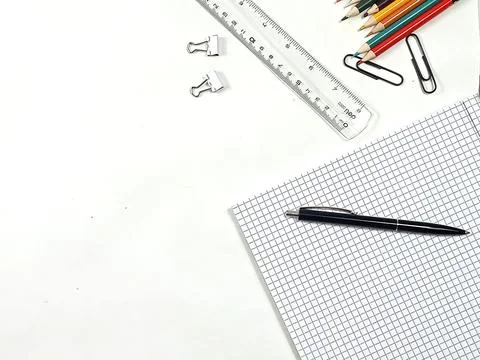 Stationery items on a checkered background. Stock Photos