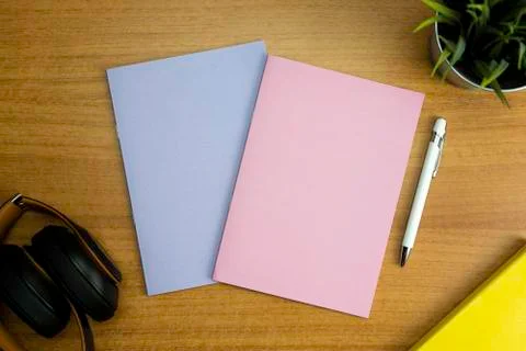 Stationery set with various objects with two colored empty notebooks one pink Stock Photos