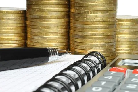 Stationery with stack of coins . Stock Photos